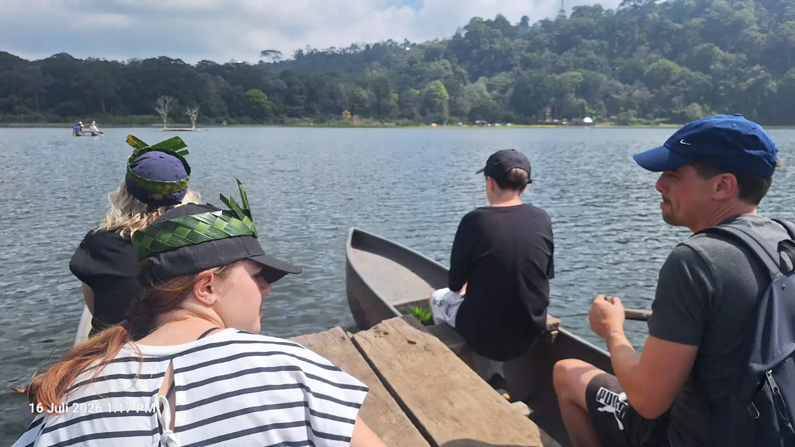 Our guests in a wooden canoe on Lake Bratan, July 2026